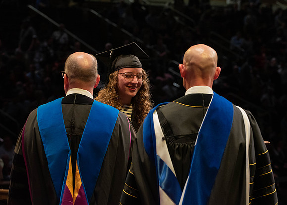 Students graduate and walk to receive their diplomas during convocation in the College of Physical Sciences and Engineering.