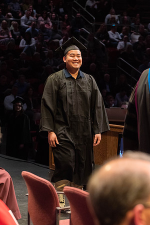 Students graduate and walk to receive their diplomas during convocation in the College of Physical Sciences and Engineering.