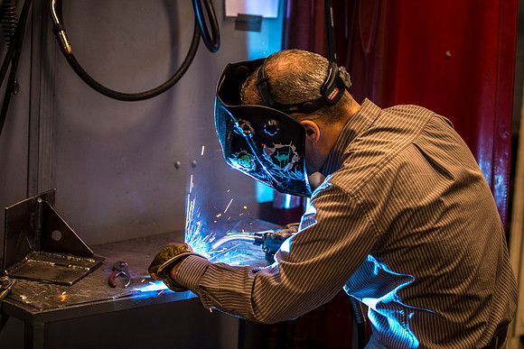Clay Rasmussen, from the Mechanical Engineering Department, welds during a demonstration.