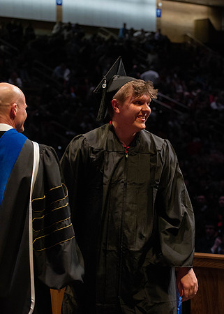 Students graduate and walk to receive their diplomas during convocation in the College of Physical Sciences and Engineering.