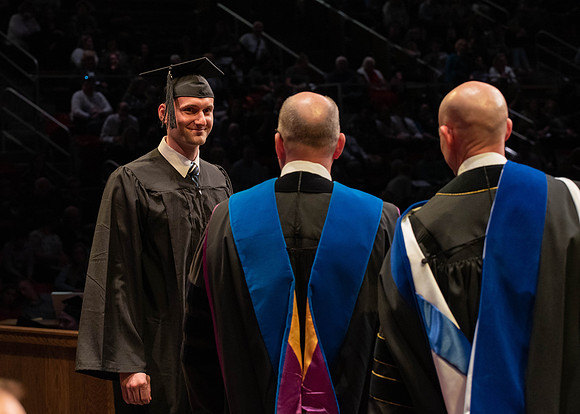 Students graduate and walk to receive their diplomas during convocation in the College of Physical Sciences and Engineering.