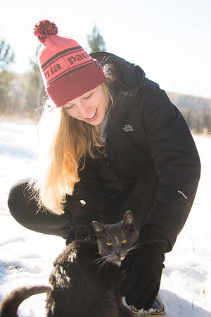 Catie Simons plays with cat at Badger Creek during iGrow.