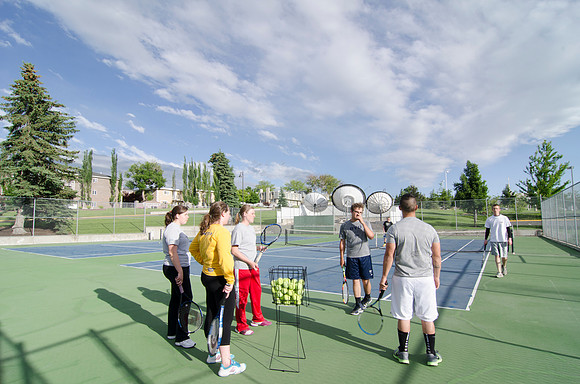 Students practicing at the Tennis Courts