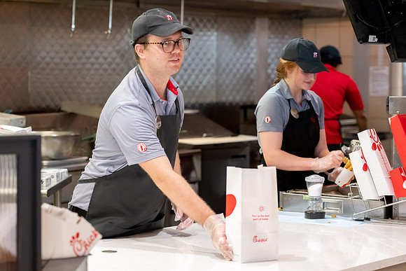Employees of the Chick-Fil-A on the BYU-Idaho campus working and helping students.