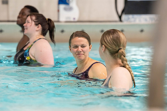 Students workout together in the pool at the Hart Building. Water Areobics Class taught by an instructor.