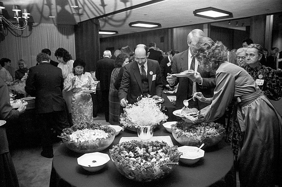 Guests at the President's Club Banquet getting food.