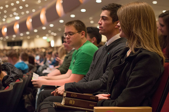 Students prepare to hear Elder and Sister Bednar speak at devotional.