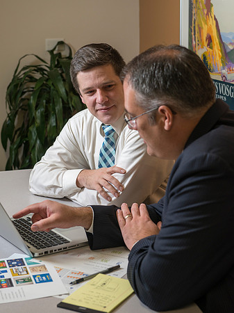 Arnold Thiebaud, Creative Services manager and Director of Marketing Communciations discusses a project with Jed Rhein the MarComm Graphic Designer.