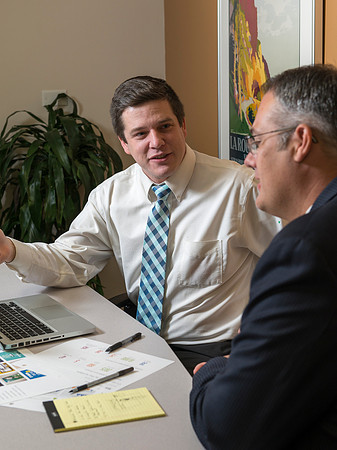 Arnold Thiebaud, Creative Services manager and Director of Marketing Communciations discusses a project with Jed Rhein the MarComm Graphic Designer.