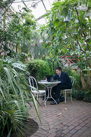 A student finds a quite place to study in the Benson Building Greenhouse.