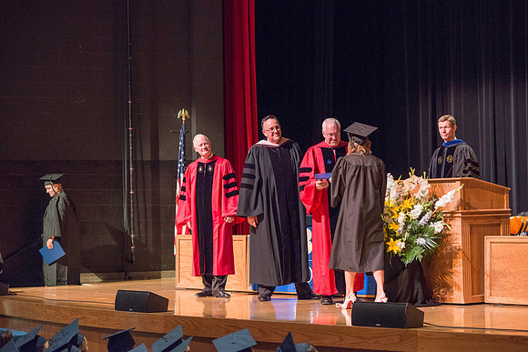 Elder Robert C. Gay of the First Quorum of the Seventy along President Kim B. Clark and John Linford, Dean of the College of Foundations and Interdisciplinary Studies present the graduates with thier