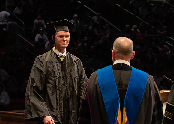 Students graduate and walk to receive their diplomas during convocation in the College of Physical Sciences and Engineering.
