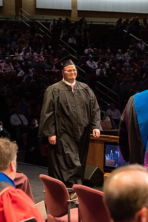 Students graduate and walk to receive their diplomas during convocation in the College of Physical Sciences and Engineering.