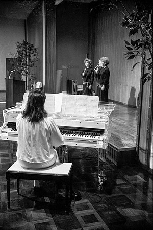 Members of a trio sing a song