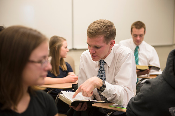 Students help and teach one another in Brother Peterson's religion class.