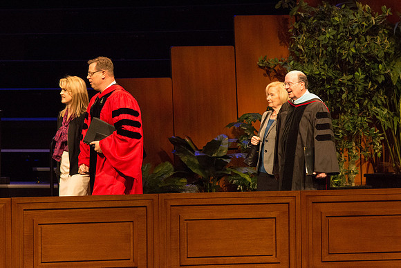 President Clark G. Gilbert and Elder Quentin L. Cook walking out in the graduation processional
