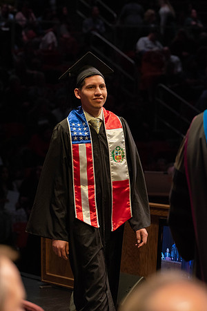 Students graduate and walk to receive their diplomas during convocation in the College of Physical Sciences and Engineering.