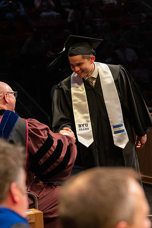 Students graduate and walk to receive their diplomas during convocation in the College of Physical Sciences and Engineering.