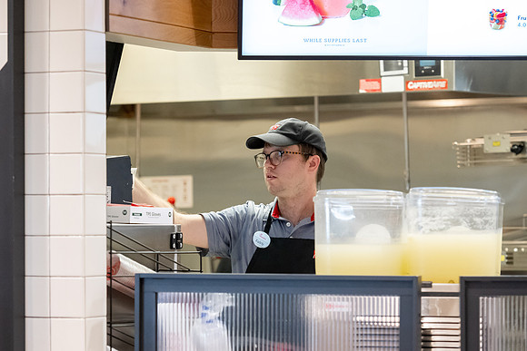 Employees of the Chick-Fil-A on the BYU-Idaho campus working and helping students.