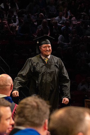 Students graduate and walk to receive their diplomas during convocation in the College of Physical Sciences and Engineering.