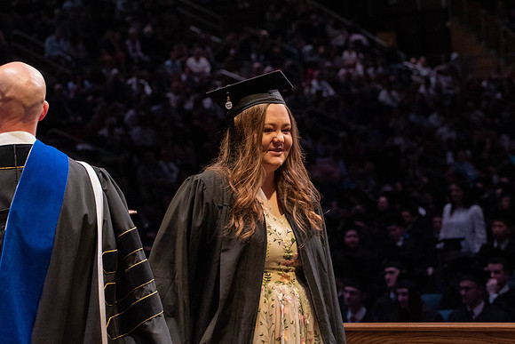 Students graduate and walk to receive their diplomas during convocation in the College of Physical Sciences and Engineering.