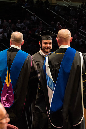 Students graduate and walk to receive their diplomas during convocation in the College of Physical Sciences and Engineering.