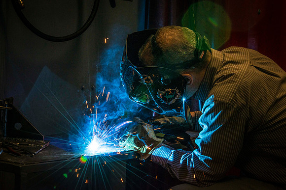 Clay Rasmussen, from the Mechanical Engineering Department, welds during a demonstration.