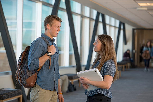 BYU-Idaho students, Collin and Martina in the Skywalk between the Manwaring Center and the McKay Library.
