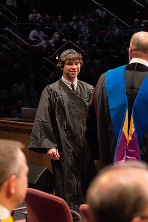 Students graduate and walk to receive their diplomas during convocation in the College of Physical Sciences and Engineering.