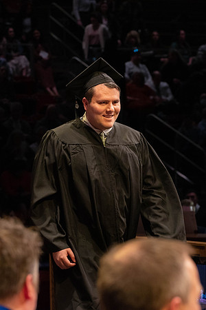 Students graduate and walk to receive their diplomas during convocation in the College of Physical Sciences and Engineering.