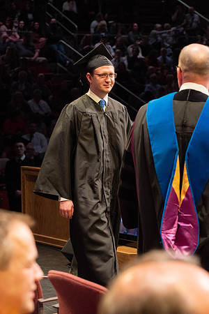 Students graduate and walk to receive their diplomas during convocation in the College of Physical Sciences and Engineering.