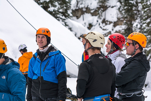 Davin Lybbart with students belaying other students ice climbing.