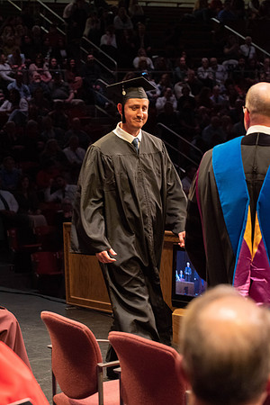 Students graduate and walk to receive their diplomas during convocation in the College of Physical Sciences and Engineering.