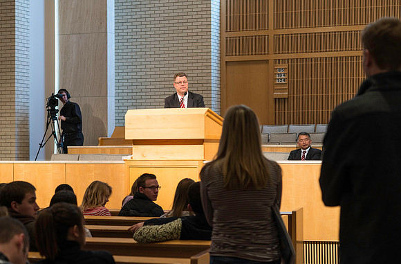 President Gilbert listens and answers questions from students during a Q&A.