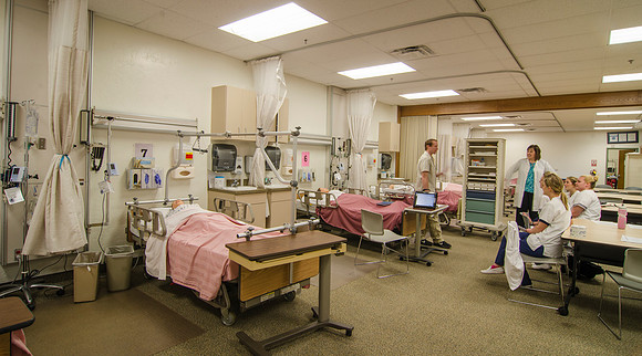 Nursing students work with their instructor in the John L. Clarke Nursing Lab.