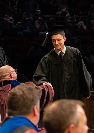 Students graduate and walk to receive their diplomas during convocation in the College of Physical Sciences and Engineering.