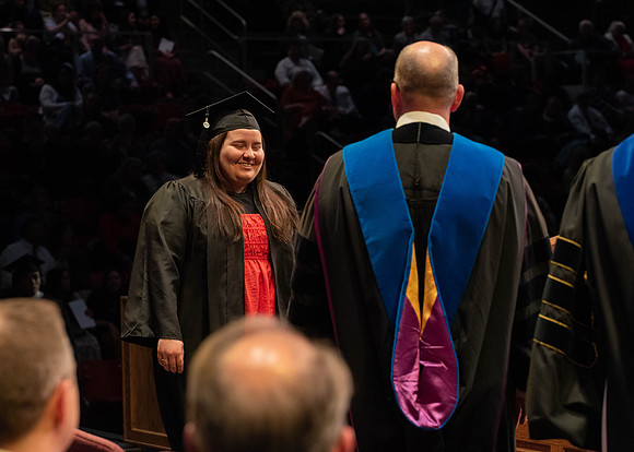 Students graduate and walk to receive their diplomas during convocation in the College of Physical Sciences and Engineering.