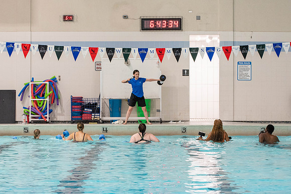 Students workout together in the pool at the Hart Building. Water Areobics Class taught by an instructor.