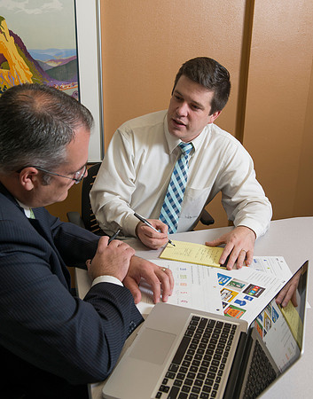 Arnold Thiebaud, Creative Services manager and Director of Marketing Communciations discusses a project with Jed Rhein the MarComm Graphic Designer.