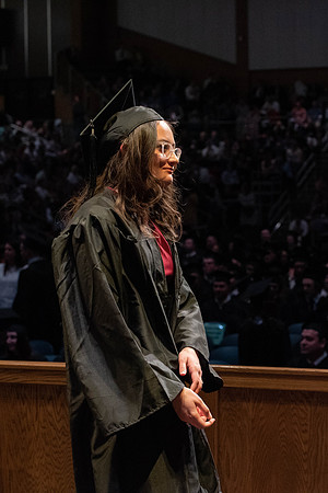 Students graduate and walk to receive their diplomas during convocation in the College of Physical Sciences and Engineering.