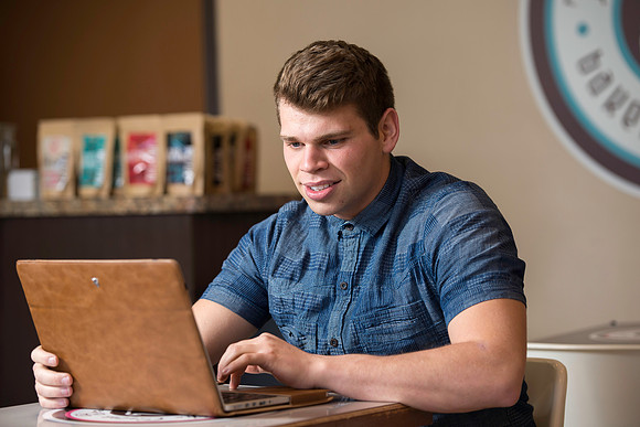 Blake Jensen studies for an Online class at the Cocoa Bean Cafe in Rexburg, ID.