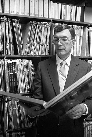 Lamar Barrus looking through old records.