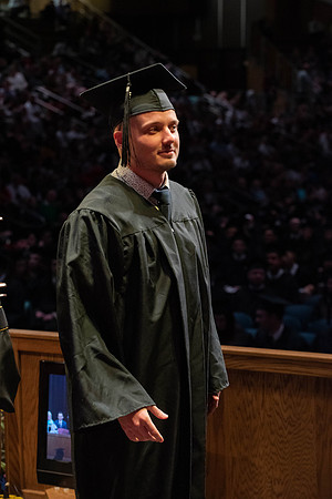 Students graduate and walk to receive their diplomas during convocation in the College of Physical Sciences and Engineering.