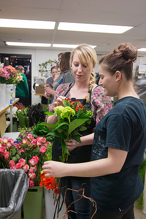 Horticulture students prepare for a semester review fashion show that will show their floral designs as well. Brother Romney leads the students along with other instructors.
