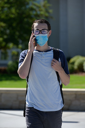 Student volunteers show the way to stay safe during this COVID 19 pandemic by social distancing, following pathway arrows and proper wearing of masks .