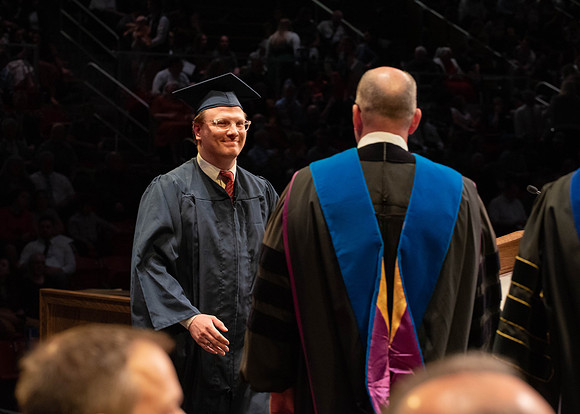 Students graduate and walk to receive their diplomas during convocation in the College of Physical Sciences and Engineering.