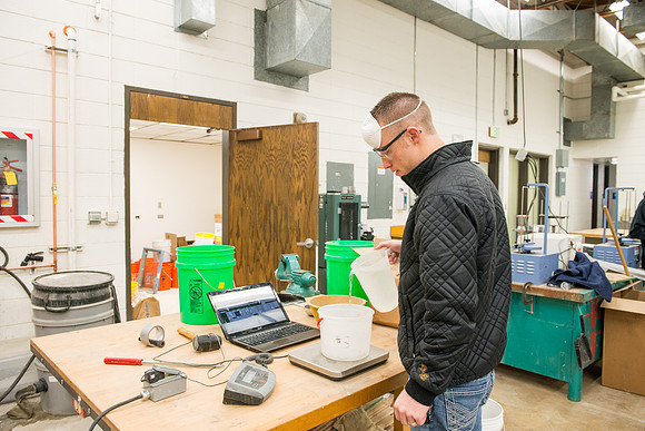 Civil engineering students work with different mixtures of cement to make a light, yet durable, cement that will be the building material for a canoe.