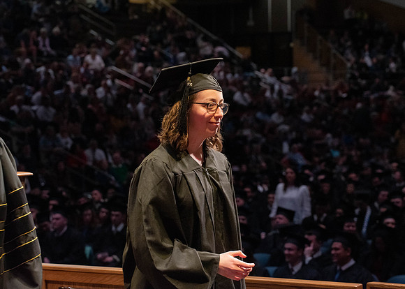 Students graduate and walk to receive their diplomas during convocation in the College of Physical Sciences and Engineering.