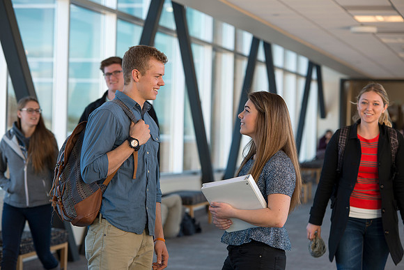 BYU-Idaho students, Collin and Martina in the Skywalk between the Manwaring Center and the McKay Library.