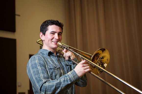 Roman Daves, a freshman at BYU-Idaho, practices with his trombone in the Snow Building.